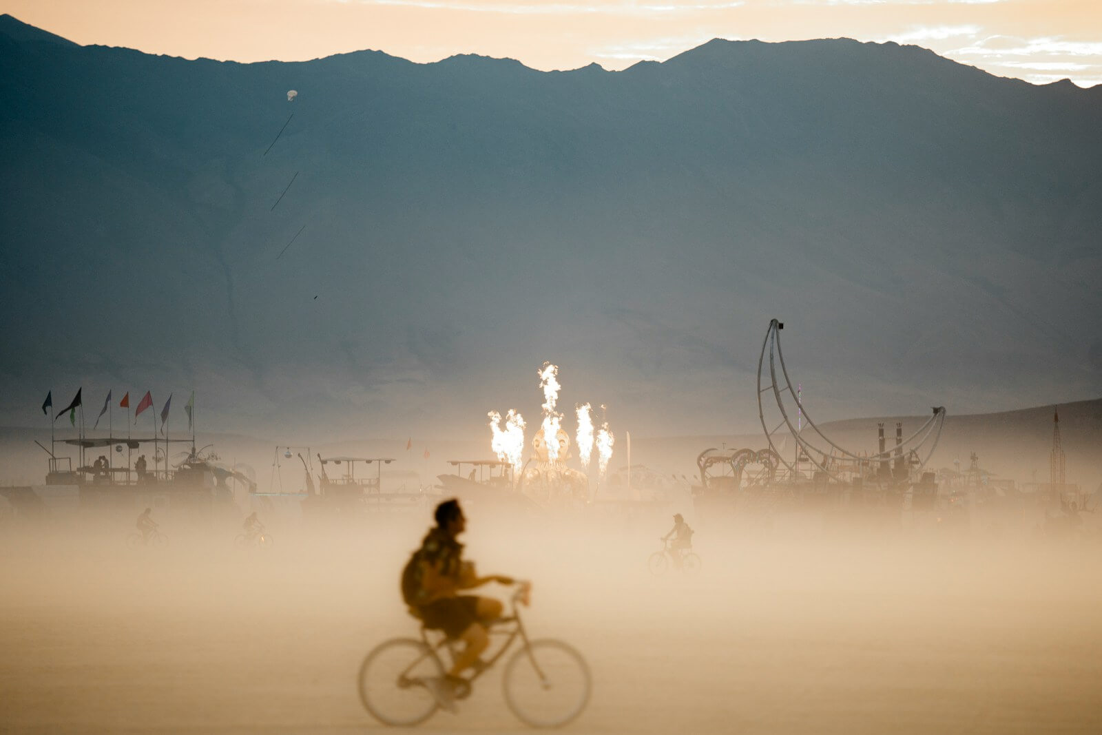 A person riding a bike on a foggy day